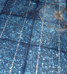 a solar
panel with a large impact crater; the glass has cracked into thousands of
peices but is still hanging together