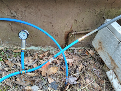 water pressure guage connected to
PEX pipe coming out of trench and connecting to copper pipe that goes into
house