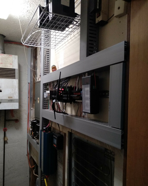A cramped utility room with an entire wall
covered with electronic gear, including the DIN rail, which is surrounded by
wire gutters