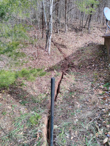 30 feet of very narrow trench
comes out of the woods and along the side of the house past the satellite
internet dish